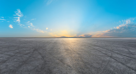 Asphalt road pavement and dramatic sky at sunset