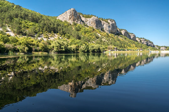 Reflection of a mountain in the lake Mangup, Crimea