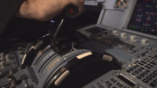 The cockpit of the aircraft. The pilot checks the aircraft engines before takeoff. Preparation of passenger airliner for takeoff. The pilot adjusts the autopilot. 4k