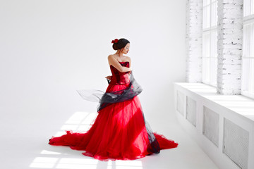 A young woman in a red dress is dancing. Latin style. Isolate on white - obrazy, fototapety, plakaty