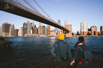 Asian couple holding hand at Brooklyn bridge, NYC USA