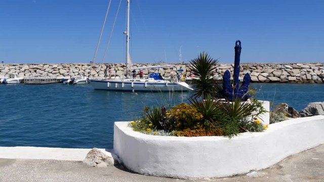 Spanish Marina in Puerto de La Duquesa in The Costa del Sol in Spain.
Camera = Static shot of yacht sailing into the marina.