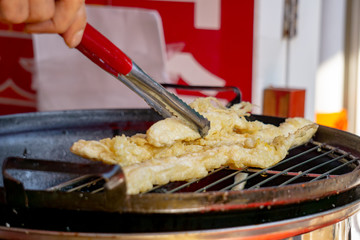 Golden crispy fried ginseng served as snack or sidedish for healthy and energy boosting. Fried ginseng is a Famous food saled in tourism destination in South Korea.