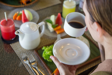 Young woman having the first-morning coffee during breakfast time, the concept of a healthy morning routine lifestyle
