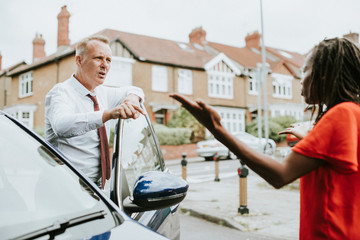 People arguing after a car accident