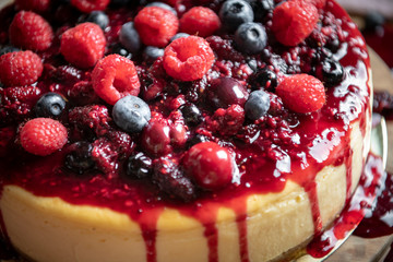 Closeup of a cheesecake covered with mixed berries