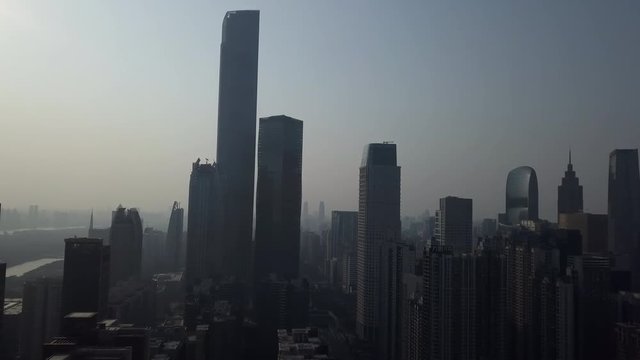 Aerial shot of mega city Guangzhou Central building district (CBD) with office building skyscrapers on a sunny day in the afternoon