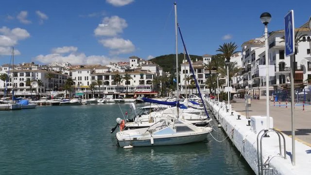 Spanish Marina in Puerto de La Duquesa in The Costa del Sol in Spain.
Camera = Static shot of boats and street
