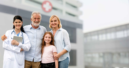 Doctor with happy family of mother, father and daughter at the hospital. Medical healthcare and...