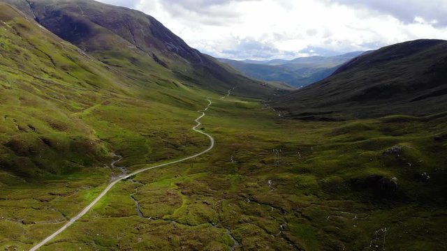 Aerial 4K Drone mountain footage of Hiking trail (West Highland Way) landscape in Scottish Highlands between Kinlochleven and Fort William in Scotland during the summer of 2018
