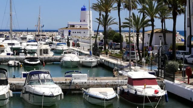 Spanish Marina in Puerto de La Duquesa in The Costa del Sol in Spain.
Camera = Static high shot of boats in Marina and Beacon