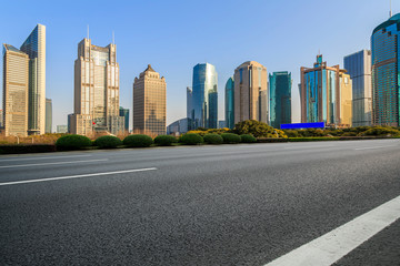 Fototapeta na wymiar City skyscrapers and road asphalt pavement