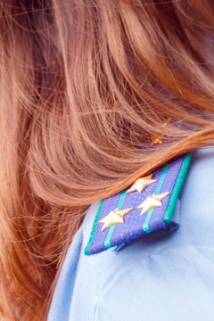 Colonel's shoulder straps on a woman's shoulder by a policeman.