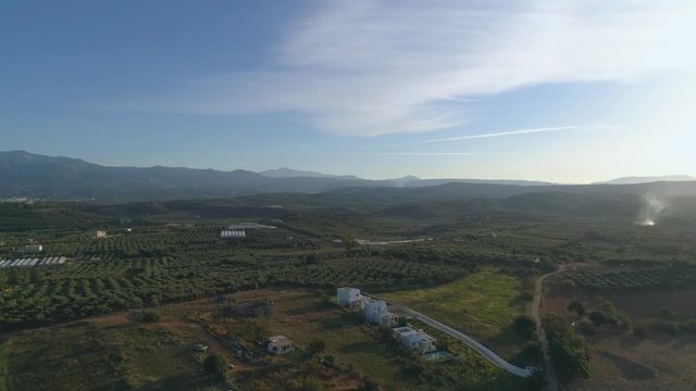 Aerial view flying over fertile farmland and trees on the island of Crete, Greece