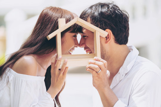 Young Couple Planning To Buy A House And Have Happy Living.