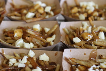Boxed trays with poutine which consists of french fries, cheese and gravy