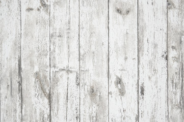 Fototapeta na wymiar Old weathered wood surface with long boards lined up. Wooden planks on a wall or floor with grain and texture. Light neutral flat faded tones.