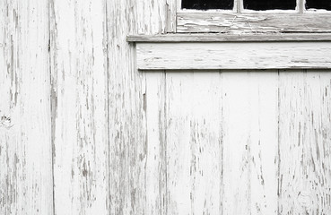 Old weathered wood boards or siding. Wooden planks on a wall with window. Light neutral flat faded toned texture.
