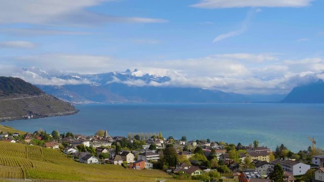 Cully (Switzerland) and Lake L&radic;&copy;man on a cold windy autumn day. Snow covered alpine summits in the background.