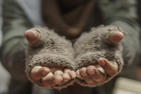 Close up hands of older homeless dirty poor beggar man waiting to help from donor. He so hungry, unhappy, have not money and feel lonely.