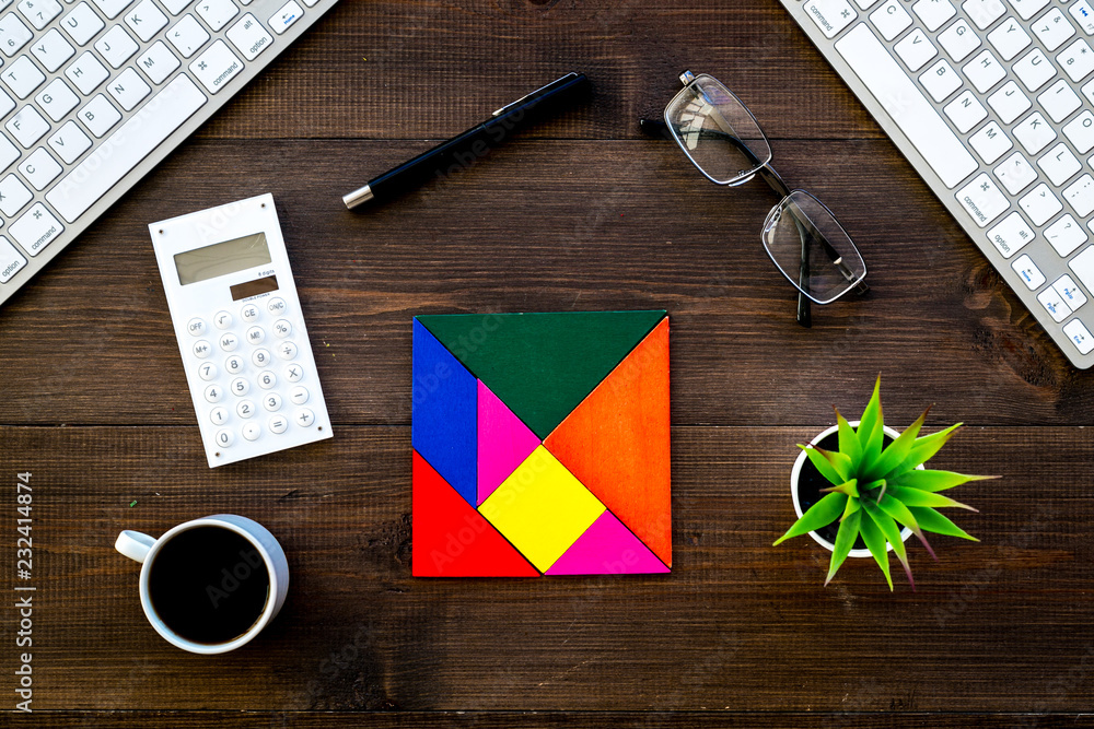 Poster teamwork in business concept. assembled puzzle on dark wooden office desk with computer keyboard top