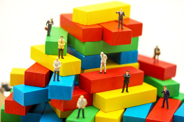 Fototapeta premium Miniature business people sitting on wood block , recruitment finding employee and business concept.