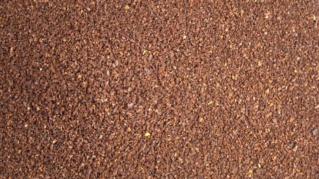 Fresh roasted coffee grounds spinning video close up