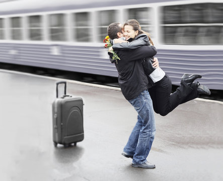 Young couple happy to meet again in the train station
