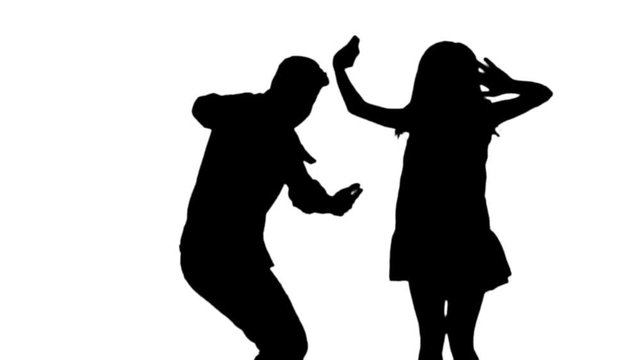 Slow motion silhouette, jumping and dancing by a man and a woman.