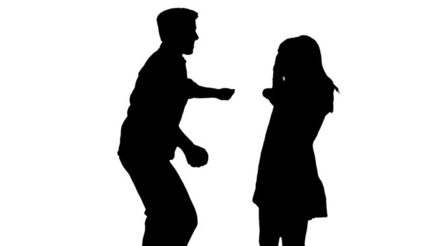 Slow motion silhouette of a couple, danceing happily .