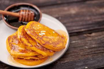 pancake with honey on wooden background
