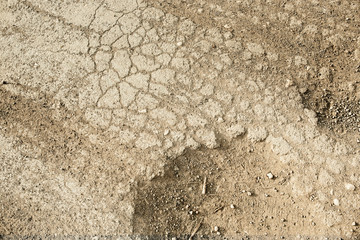 Wheel trace on road .Traces on soil of tractor, excavator, car, automotive tire tracks on muddy trail. Background, texture