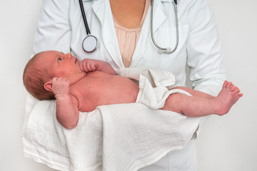 Pediatrician doctor is holding newborn baby in arms © andriano_cz