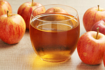 A glass with juice and apples	