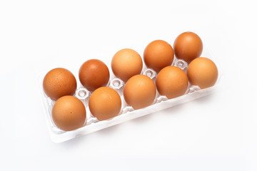 Chicken eggs in plastic package on white background.
