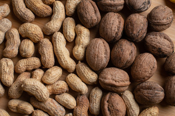 Walnuts kernels on dark desk with color background, Whole walnut in wood vintage bowl, Nuts in bamboo wooden bowl, walnuts in wood bamboo bowl