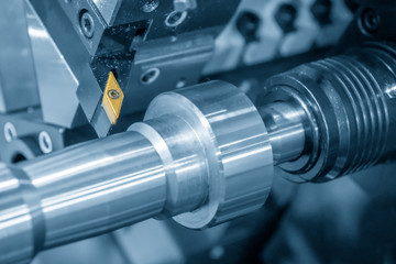 The cutting tool for CNC lathe machine .The CNC lathe machine cutting  the steel shaft in the light...