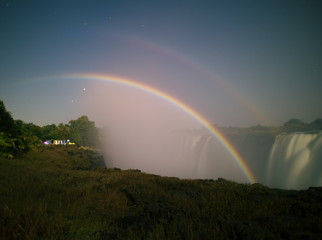 Victoria Falls,Zimbabwe-August 17, 2016: A lunar rainbow or a moonbow on the Victoria Falls observed within 2 days of full moon. 
