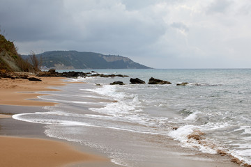 Beautiful seascape with turquoise water, cliffs and the sea. Sunny warm tropical day. Background for travel on the Mediterranean. Greece. Europe