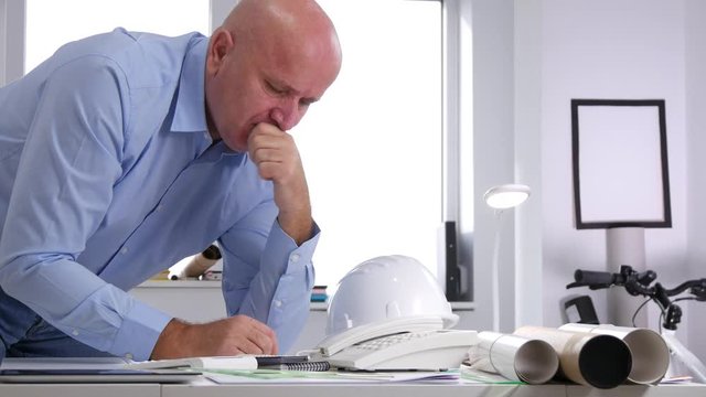 Engineer Looking Worried to Some Technical Projects and Gesticulate Disappointed