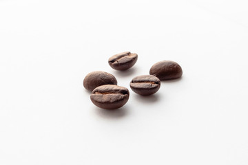 Roasted coffee beans on white background.