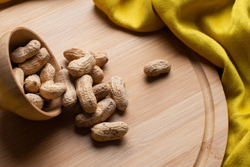 Walnuts kernels on dark desk with color background, Whole walnut in wood vintage bowl, Nuts in bamboo wooden bowl, walnuts in wood bamboo bowl