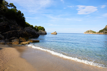 Beautiful seascape with turquoise water, cliffs and the sea. Sunny warm tropical day. Background for travel on the Mediterranean. Greece. Europe