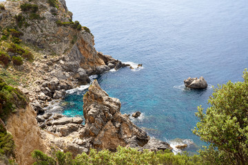 Beautiful seascape with turquoise water, cliffs and the sea. Sunny warm tropical day. Background for travel on the Mediterranean. Greece. Europe