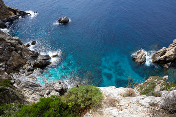 Beautiful seascape with turquoise water, cliffs and the sea. Sunny warm tropical day. Background for travel on the Mediterranean. Greece. Europe