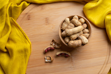 Walnuts kernels on dark desk with color background, Whole walnut in wood vintage bowl, Nuts in bamboo wooden bowl, walnuts in wood bamboo bowl