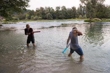 young men having fun with water guns