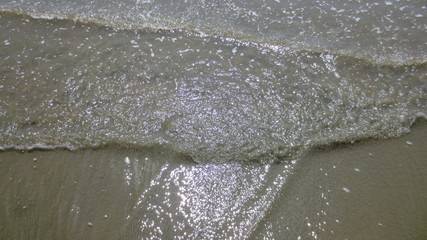 sea water foam on the beach in a sunny day of summer at Pak Meng Beach Trang province,Thailand