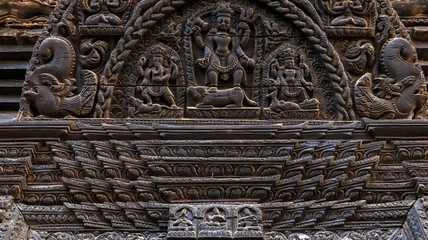 Wood carvings of Hindu Gods on the temple in Bhaktapur Durbar Square