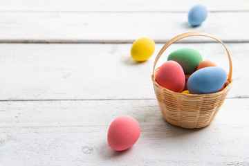 Colored easter eggs on white wooden